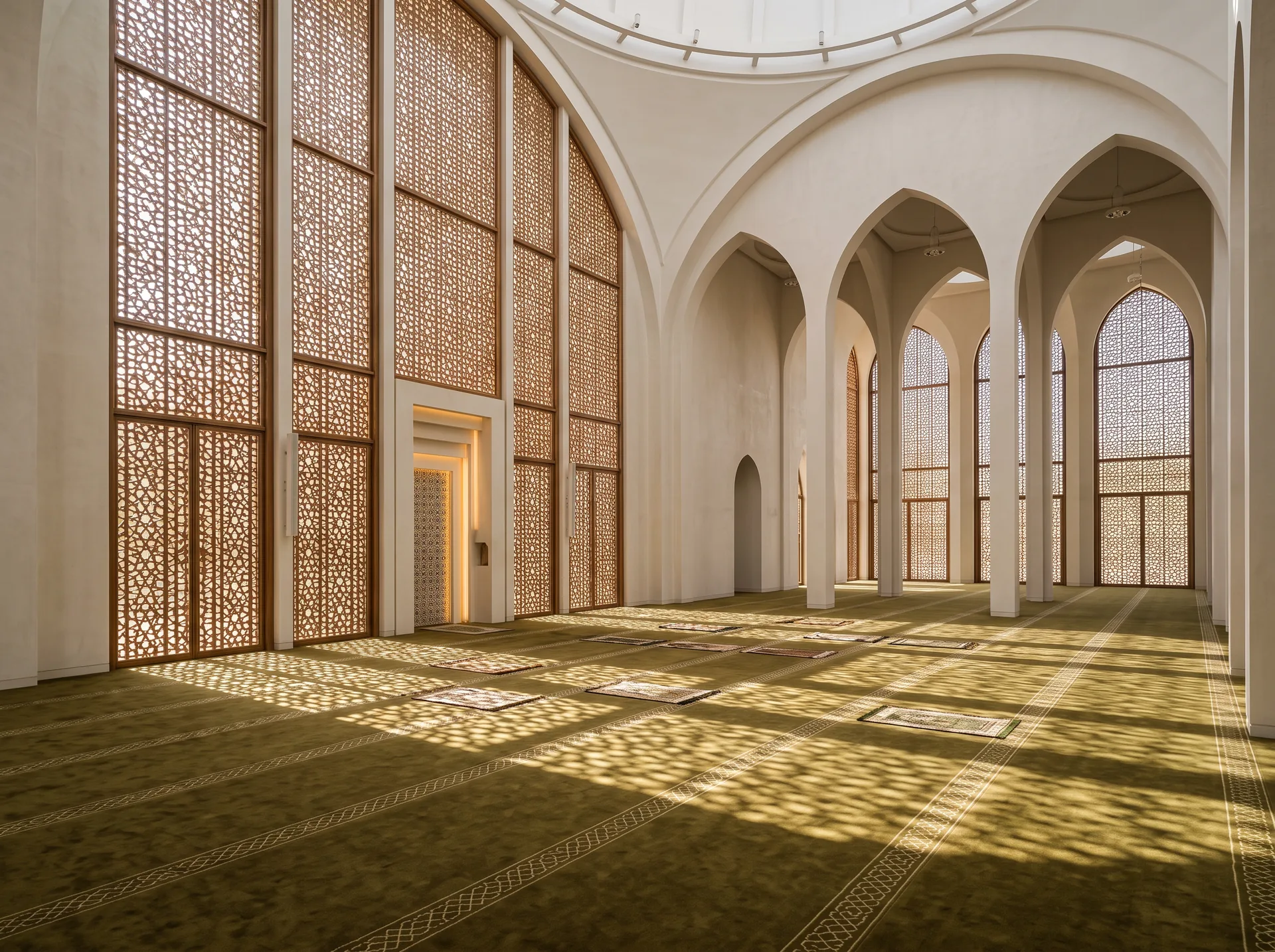 Mosque prayer hall with shafts of sunlight through perforated geometric screens